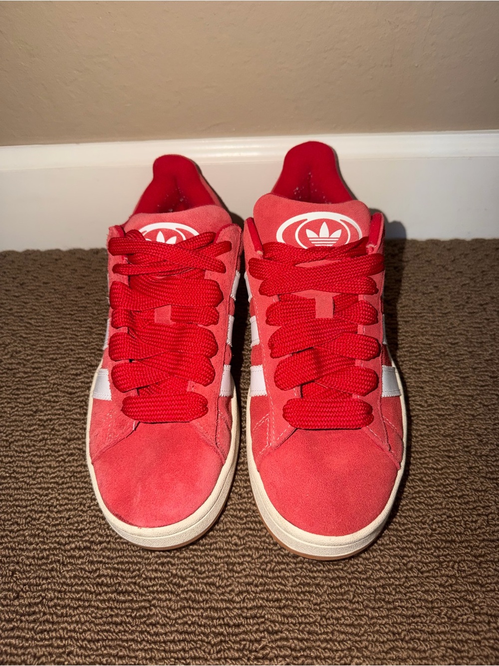 adidas Red Suede Low-Top Sneakers with White Stripes.